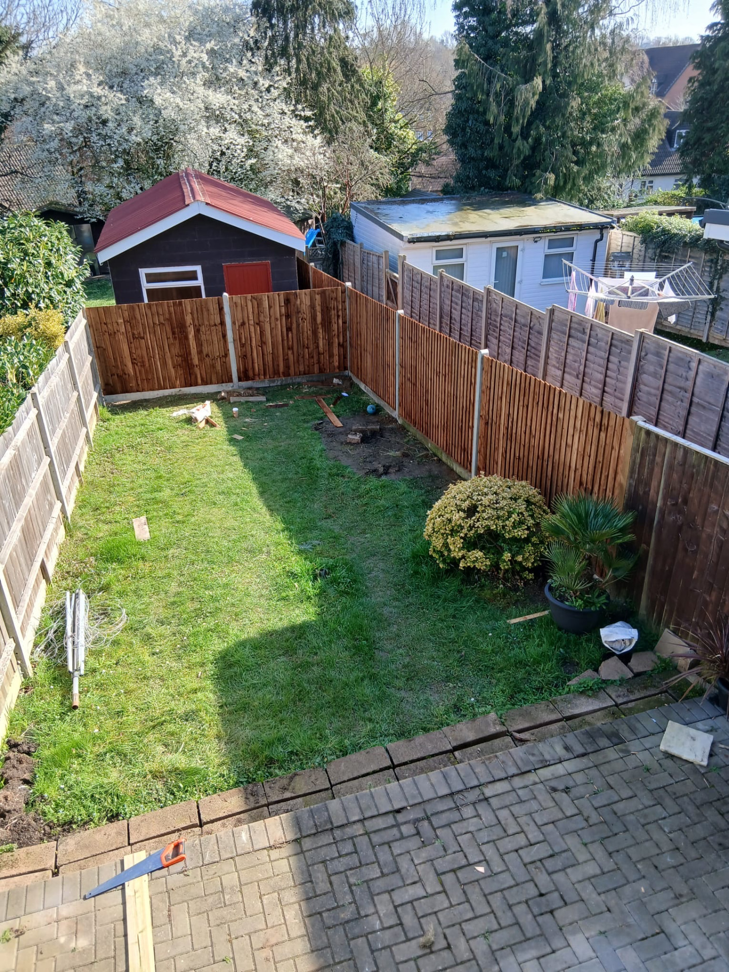 Full garden fencing project viewed from above, enclosing a neat lawn