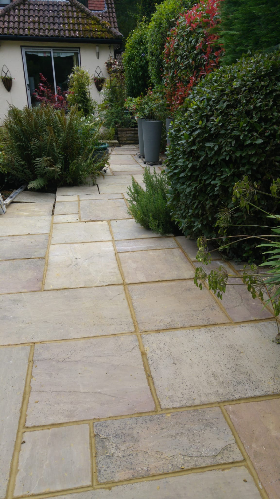 Natural stone path and patio surrounded by mature planting